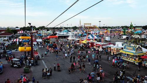 People on street against sky during nebraska state fair