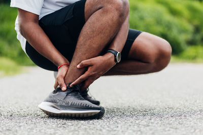 Low section of man wearing shoes on floor