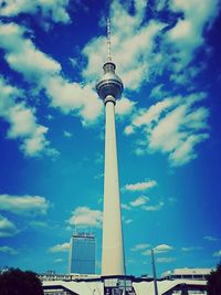 Low angle view of tower against cloudy sky