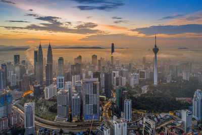 Aerial view of city buildings during sunset