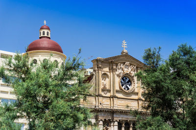 Low angle view of church against clear blue sky