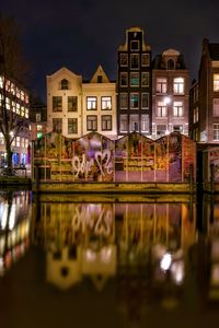 Reflection of illuminated buildings in city at night