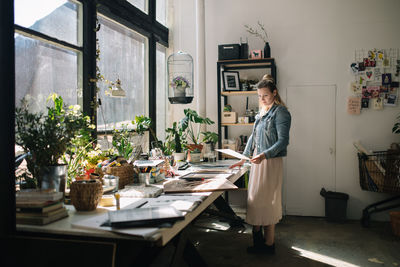 Woman working at desk in workshop