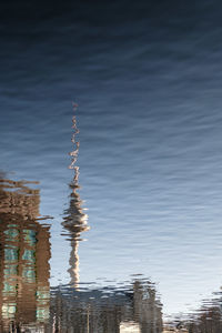 Reflection of building in water against sky