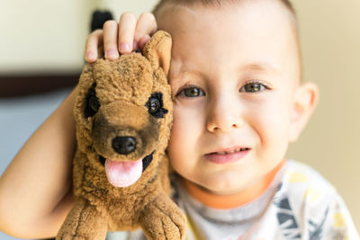 Portrait of cute boy with toy