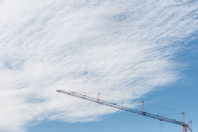 Low angle view of crane against sky