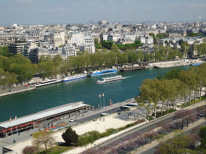 VIEW OF CITYSCAPE WITH RIVER IN FOREGROUND