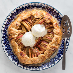 A homemade salted caramel apple galette topped with vanilla ice cream.