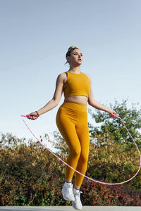 Determined young athlete exercising with jumping rope