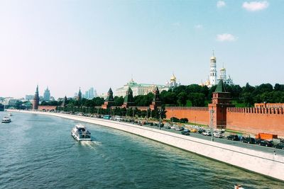 Moskva river by moscow kremlin against sky