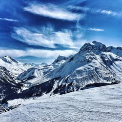 Scenic view of snow covered mountains against sky