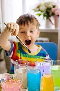 Close-up of girl painting at home