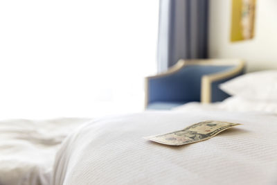 Close-up of wedding rings on bed at home