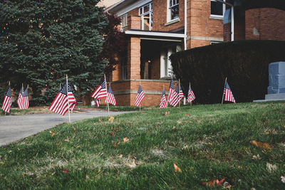 Flags on field against buildings