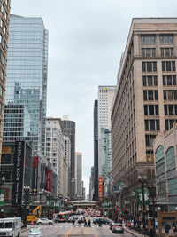 View of city street and buildings against sky