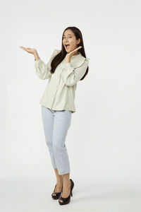 Portrait of a smiling young woman against white background