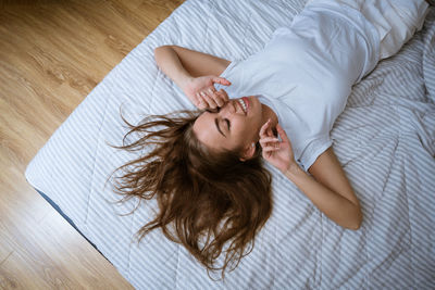 High angle view of woman lying on bed