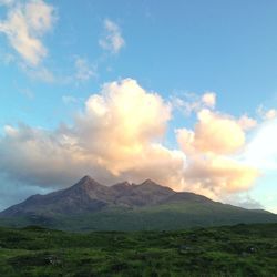 Scenic view of mountains against cloudy sky