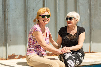 Two elderly women are happy to meet each other