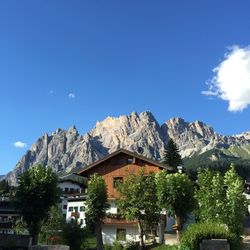 Houses against rocky mountains