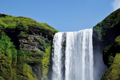 Scenic view of waterfall against clear sky