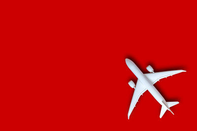 Close-up of airplane on red wall