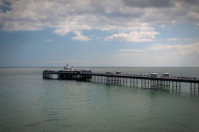 Pier on sea against sky