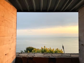 Scenic view of sea against sky seen through window