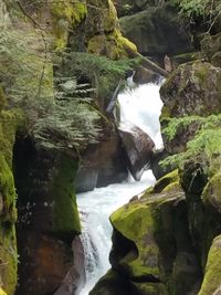 Scenic view of river flowing through rocks