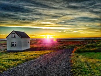 Scenic view of field against sky at sunset