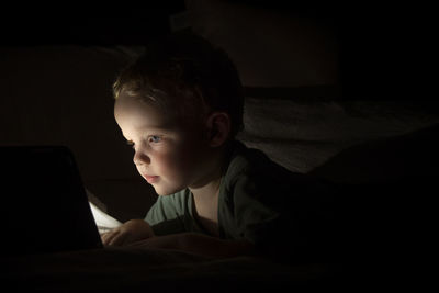Portrait of boy looking at camera at home