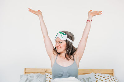 Portrait of a smiling young woman against white background