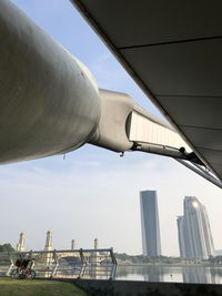 Low angle view of bridge and buildings against sky