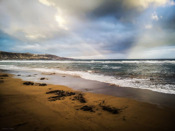 Scenic view of beach against sky