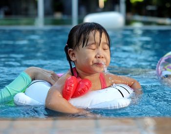 Full length of girl swimming in pool
