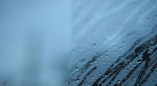 Close-up of wet railing during rainy season