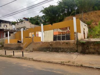 Houses by road against buildings in city