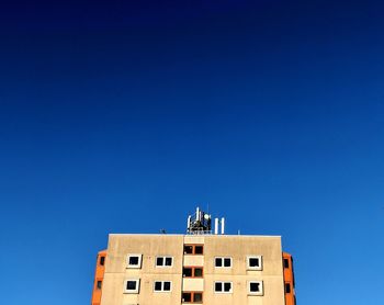 Low angle view of buildings against blue sky