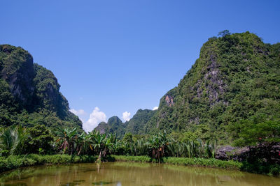Scenic view of lake and mountains against clear sky