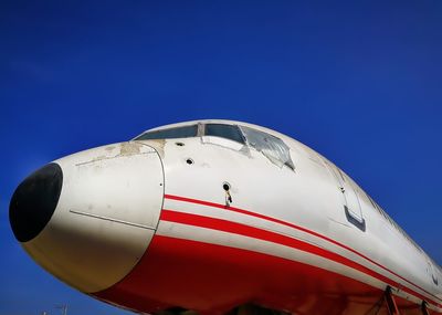 Low angle view of airplane against blue sky