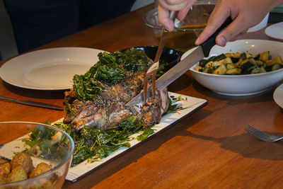 Close-up of hand holding food on table