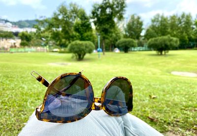 Man wearing sunglasses on field at park