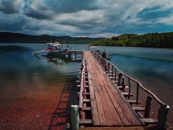 Pier over lake against sky