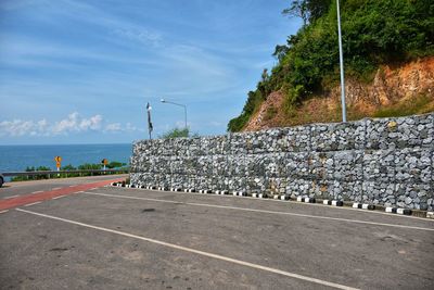 Road by sea against sky
