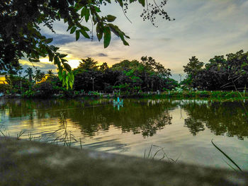 Scenic view of lake against sky at sunset