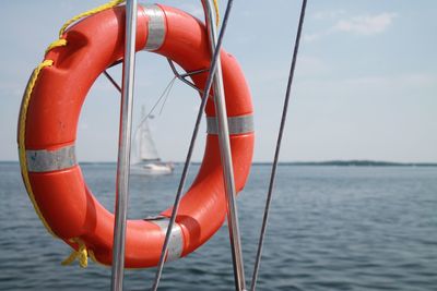 Close-up of red boat in sea against sky