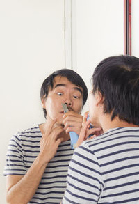 Man shaving at home