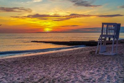 Scenic view of beach against sky during sunset