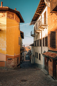 Street amidst buildings in town against sky
