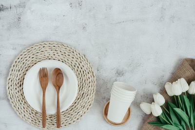 Directly above shot of white flowers in basket on table